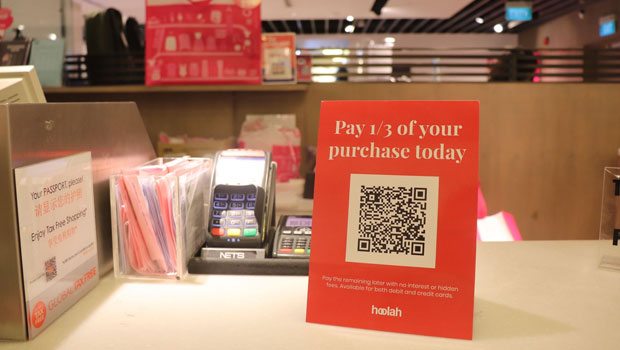 hoolah signage with QR code for payment option at the desk counter